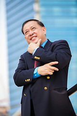 Image showing Senior Asian businessman in suit smiling portrait