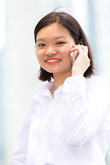 Image showing Young Asian female executive using smart phone