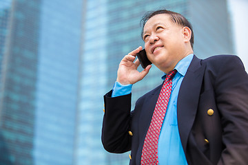Image showing Senior businessman in suit using smart phone