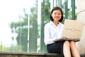 Image showing no Young Asian female executive using laptop PC