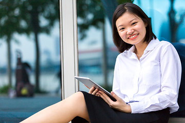 Image showing Young Asian female executive using tablet PC