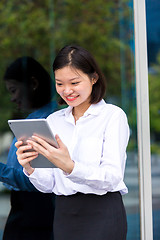 Image showing Young Asian female executive using tablet PC