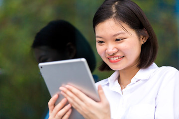 Image showing Young Asian female executive using tablet PC