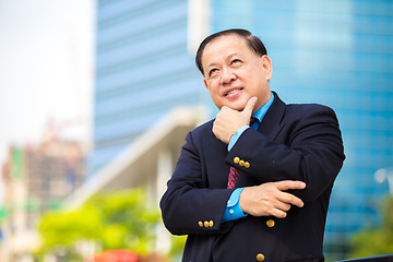Image showing Senior Asian businessman in suit smiling portrait