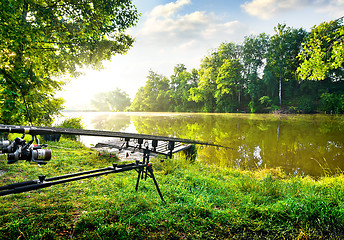 Image showing Fishing rods near river