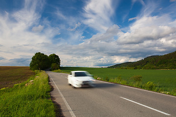 Image showing Empty road between summer field at sunset