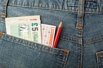 Image showing UK money and lottery bet slip in pocket