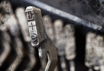 Image showing E hammer - old manual typewriter - mystery smoke