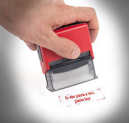 Image showing Plastic stamp in hand, isolated