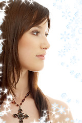 Image showing lovely brunette with cross and snowflakes