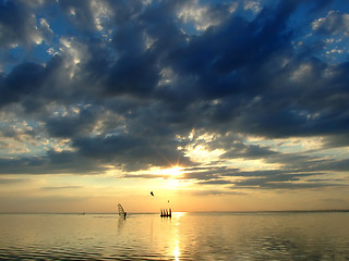 Image showing The sky and the sun in clouds above a gulf 2