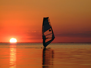 Image showing Silhouette of a windsurfer on waves of a gulf on a sunset 2