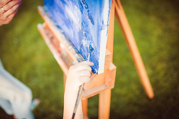 Image showing Mother and little daughter paint together