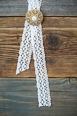 Image showing vintage lace with a brooch