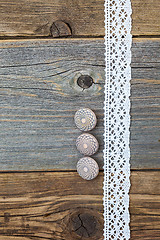 Image showing Three vintage bone buttons and lace tape