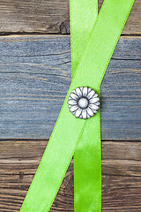 Image showing Vintage metal button flower and two green tape
