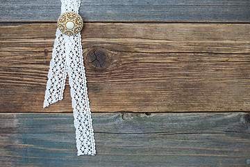 Image showing vintage lace with a brooch