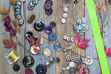 Image showing vintage buttons, reel with thread, herbarium and green tape