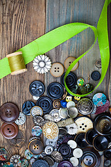 Image showing vintage buttons with green ribbon and spool with thread