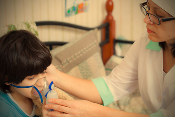 Image showing doctor pediatrician spends boy inhalation