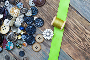 Image showing vintage buttons, spool with thread and green tape