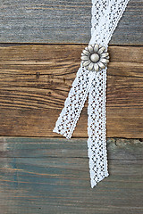 Image showing silvery button flower and lace tape