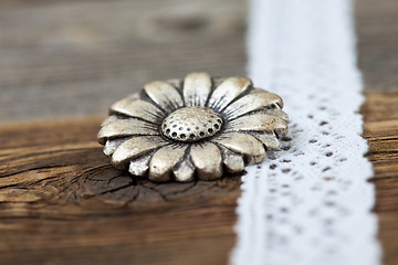 Image showing vintage metal button flower and lace ribbon