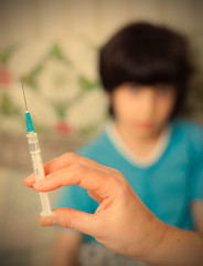 Image showing Doctor hand with syringe and child