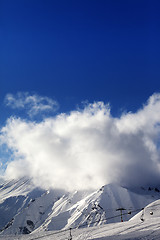 Image showing Ski slope with ropeway at sun evening