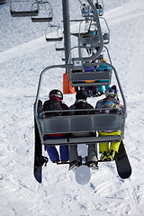 Image showing Snowboarders on chair-lift