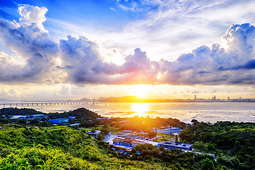 Image showing Village with beautiful sunset over hong kong  coastline. 