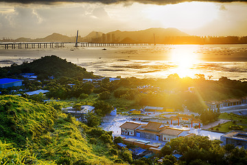 Image showing Village with beautiful sunset over hong kong  coastline. 