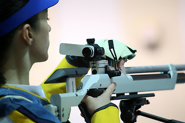 Image showing woman aiming a pneumatic air rifle