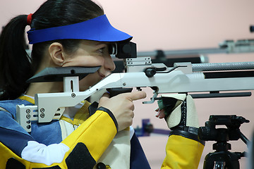 Image showing woman aiming a pneumatic air rifle