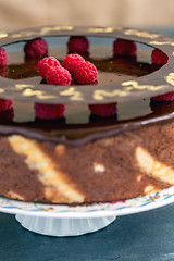 Image showing Cake with chocolate icing and raspberries