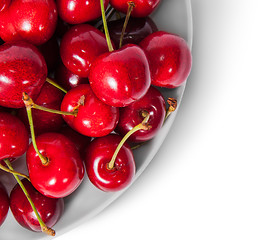 Image showing Closeup red sweet cherries in white plate top view