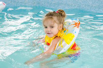 Image showing Four-year girl floating in the pool