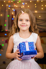 Image showing Five-year girl with Christmas gifts in his hands