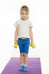 Image showing Four-year girl is preparing to raise two dumbbells
