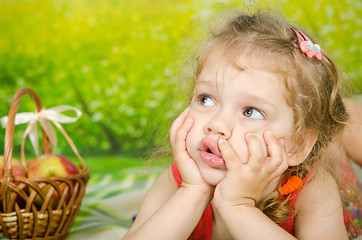 Image showing The three-year girl looked up at the picnic