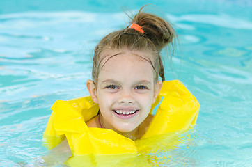 Image showing Portrait of smiling girl in a swimming pool