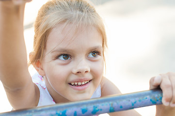 Image showing Five-year girl climbs the ladder on playground