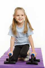 Image showing Six year old girl on a rug with stops for push-ups