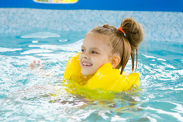 Image showing Happy girl swimming in the pool