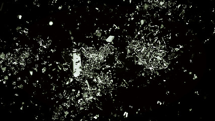 Image showing Pieces of cracked glass on black