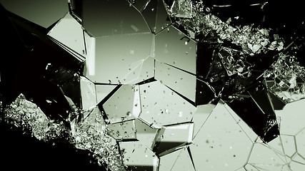 Image showing Pieces of broken or cracked glass on black