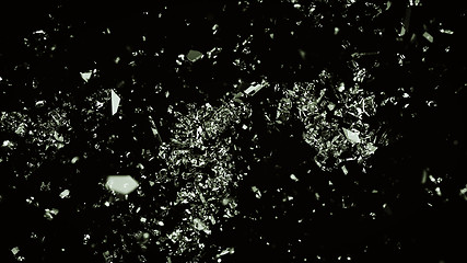 Image showing Small Pieces of splitted or cracked glass on black