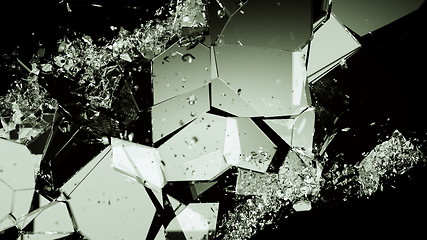 Image showing Pieces of smashed cracking glass on black