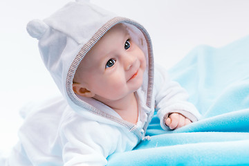 Image showing baby in the hood on a blue blanket