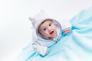 Image showing baby in the hood on a blue blanket
